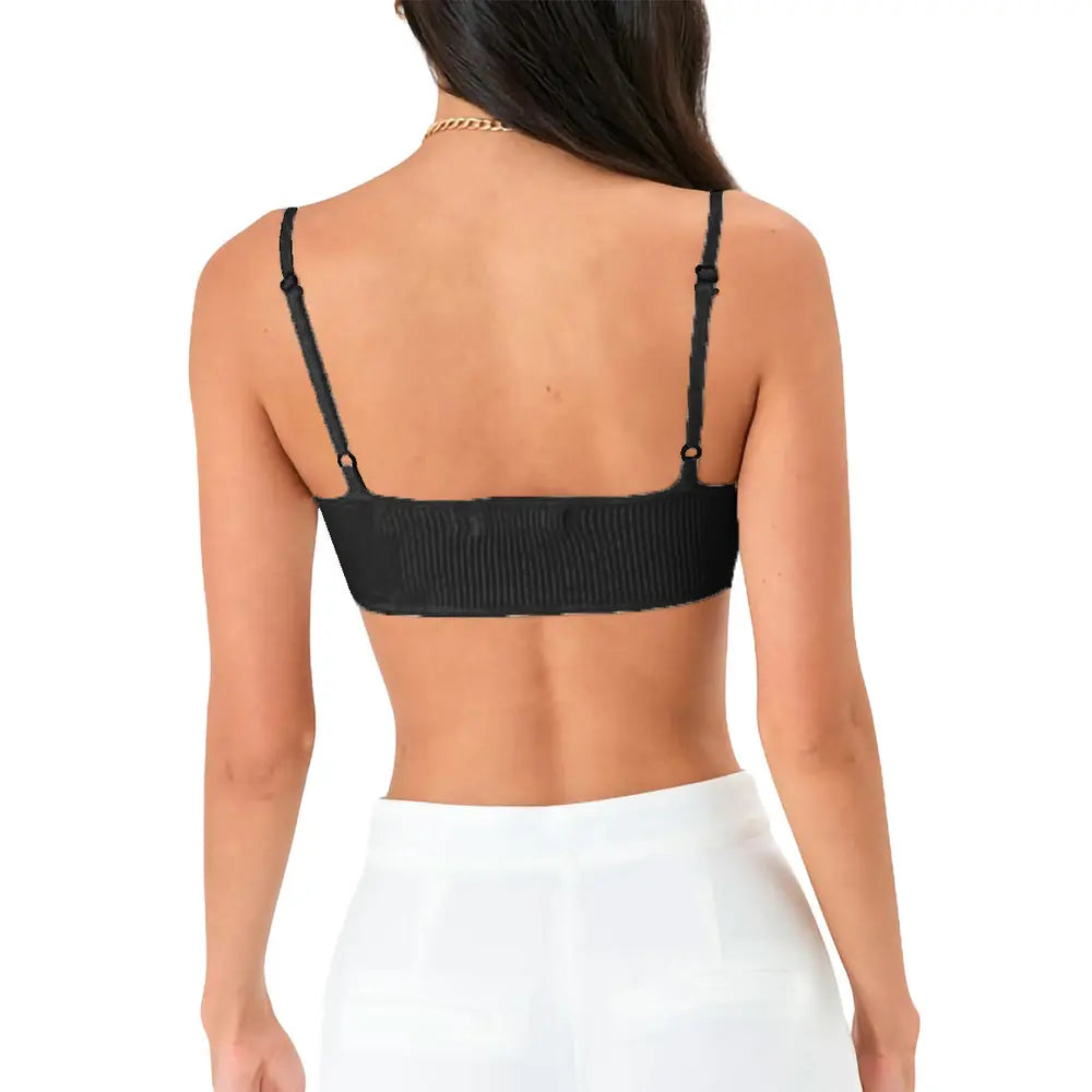 Woman in black ribbed bralette and white pants, back view, adjustable straps, lingerie