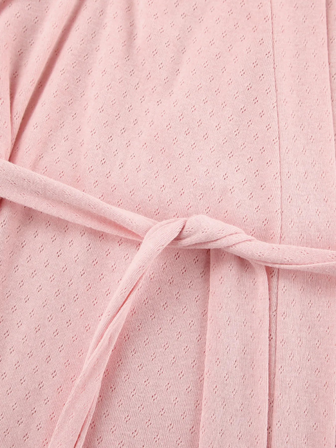Pink textured lounge wear fabric with waist tie detail and subtle dotted pattern