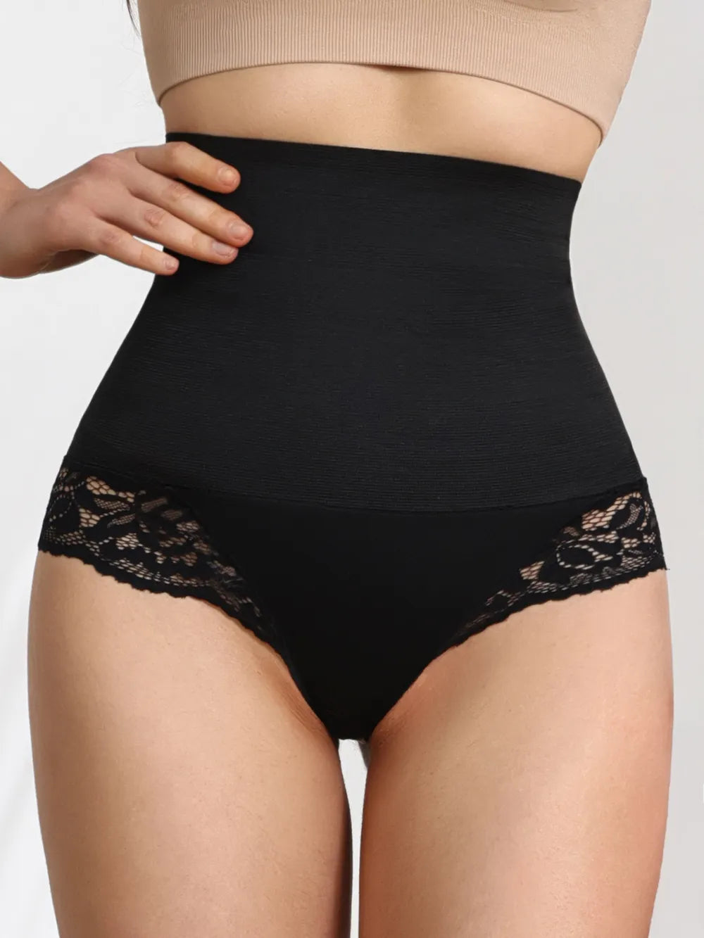 High-waisted black lace trim shaping panties for women, close-up on model