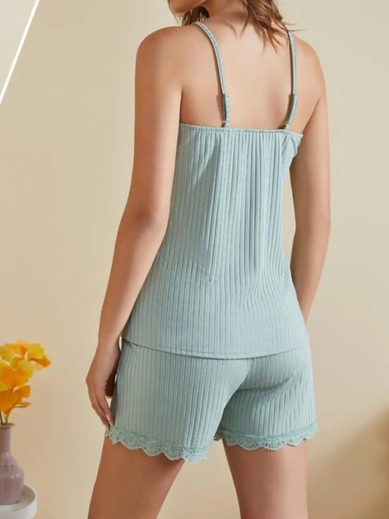 Light blue ribbed women's lounge set with lace trim shorts and camisole back view