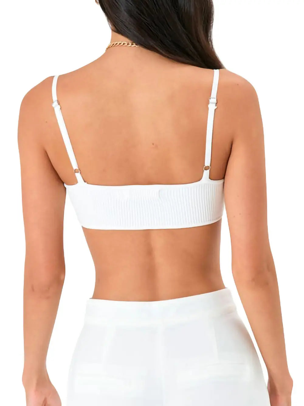 Back view of woman wearing white ribbed bralette and white lounge pants, adjustable straps